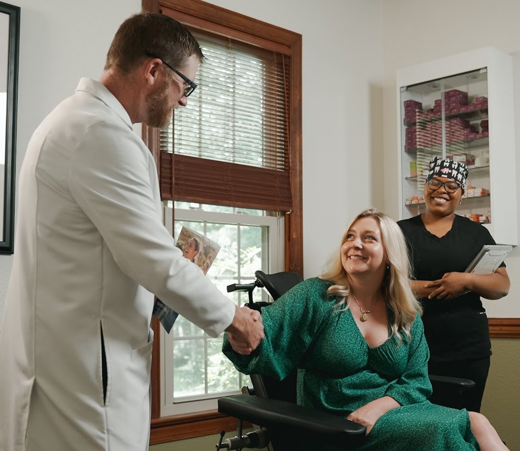 Surgeon greeting a patient in an exam room at Oral & Facial Surgery Center of Tallahassee