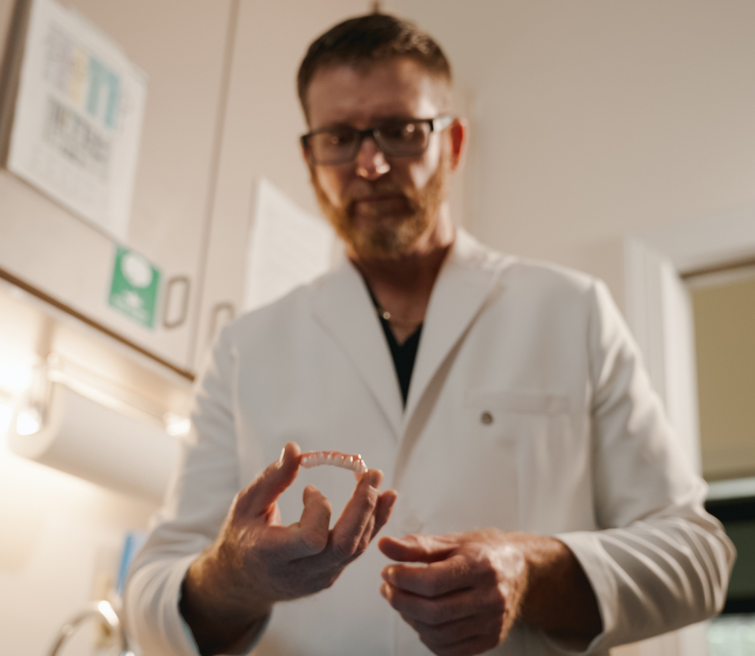 Smiling man outdoors — implant restorations fit every situation